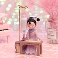 Cute Q-version Dunhuang fairy girl figurine in purple dress writing at desk - Painting Under Light