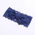 Detail of navy blue lace headband featuring double-layered bow and floral texture - Navy Blue