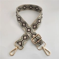 Close-up of ethnic jacquard beige shoulder strap with gold swivel hooks and geometric pattern - No. 7 Silver Buckle