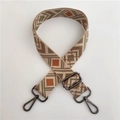 Detail of adjustable geometric jacquard strap with gunmetal hooks for crossbody bags - No.4 Green Brown + Gunmetal Buckle