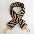 Close-up of zebra pattern wide strap with polished gold-tone metal lobster clasps - Silver Clasp / Dark Khaki