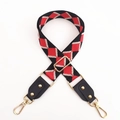 Detail of adjustable woven bag strap featuring red and black diamond pattern and gold hardware - No.9 Black Red Jacquard + Black Leather