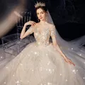 Elegant champagne lace wedding dress with sparkling sequins and off-the-shoulder design - Floor-Length