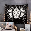 Detail of celestial skull tapestry with sun and moon stars hanging over a gray sofa - 75x50cm / Black and White Sun God