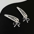 Pair of silver metal BB hair clips with bow pendants on a black textured background - 7 Bow (Pair)