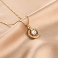 Elegant gold-plated round pendant necklace with sparkling cubic zirconia on silk fabric - Round