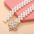 Detail of beaded pearl waist belt with gold star buckle and sparkling rhinestones - Pentagram