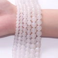 Various sizes of translucent white moonstone beads displayed on a wrist for jewelry DIY - 4mm/87pcs / White Iridescent Moonstone