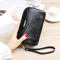 Elegant black lychee grain leather clutch bag with a golden logo plate and wrist strap - Black