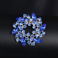 Elegant gold-plated wreath brooch featuring brilliant blue rhinestones on a dark surface - XD964-6 Royal Blue