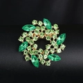 Elegant gold-tone round brooch featuring green rhinestones in a leaf-shaped wreath design - XD964-1 Green