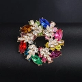 Detailed macro view of a colorful rhinestone wreath brooch with golden metal leaf accents - BR1095-5 Multicolor
