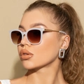 Detail of white acetate frame sunglasses with gradient lenses and gold woven temples - Jelly White Frame Gradient Tea
