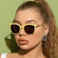 Close-up of model wearing retro hollow metal sunglasses with yellow frames and brown lenses - Jelly Yellow Frame Solid Tea