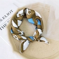 Elegant khaki silk square scarf with vintage camera pattern on textured tray - Horse Pattern Camel
