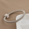 Macro shot of silver mesh bracelet featuring a sparkling rhinestone-encrusted slider bead - Steel Color