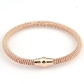 Detail view of rose gold woven cable bracelet featuring a secure magnetic clasp - Rose Gold