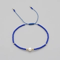 Handmade Bohemian blue beaded bracelet with white pearl and adjustable cord - Dark Blue
