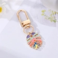 Colorful enamel leaf keychain with gold spring hook and vibrant decorative charms - Colorful Enamel Large Feather / Multicolor/Gold