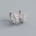 Macro detail of leaf-shaped S925 sterling silver earrings with sparkling pavé crystals - 925 Silver / White Gold