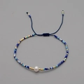 Handmade Bohemian blue beaded bracelet with natural pearl and adjustable woven cord - Blue