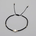 Handmade bohemian beaded bracelet featuring black beads and a white natural pearl - Black