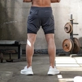 Pantalones cortos deportivos 2 en 1 para hombre gris carbón con bolsillo y tejido técnico - Negro y Gris