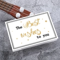 Modern white 'Best wishes' greeting card with gold artistic font on a ukulele - The Bestwishes To You