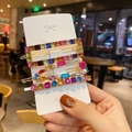 Detail of four-piece gold hair clip set with colorful gemstones and faux pearls on card - Style B (4Pcs Colorful Gemstone Set)