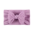 Detailed knit texture of lavender nylon baby headband with a large decorative bow - Purple