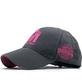 Détail d'une casquette gris foncé avec broderie M EXPLORE rose et bordure effet usé - Réglable / Gris