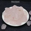 Natural raw rose quartz crystal stones in a white bowl on dark textured background - Rose Quartz