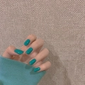 Glossy lake blue short square press-on nails shown on hand with matching knitwear - Glossy Teal Short Square Round Nails (Jelly Glue Style) (JP773)