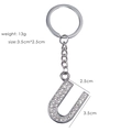 Detailed view of silver letter U keychain with rhinestones, 3.5cm charm size and 13g weight - Letter U