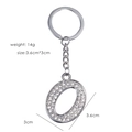 Silver letter O keychain with rhinestones, size 3.6x3cm and weight 14g on white background - Letter O