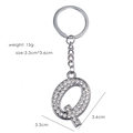 Silver letter Q keychain with sparkling crystals showing weight 15g and size 3.3x3.6cm - Letter Q