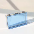 Macro detail of transparent blue acrylic evening clutch bag with gold metal frame - Transparent Blue