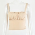 Close-up detail of beige pleated crop top featuring ruched chest design on a mannequin - S / Khaki