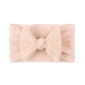 Close-up of peach cable knit texture and soft bow detail on baby nylon headband - Nude Pink