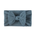 Detail of soft greyish blue knitted baby headband with a jacquard bow for newborns - Navy Blue