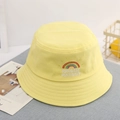 Close-up of rainbow embroidery and text on a yellow cotton kids bucket hat detail - 52cm / Yellow