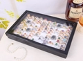 Detailed view of a black ring display box with 100 slots and a clear glass lid - 30x18cm White Ring Box