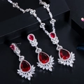 Macro detail of bridal jewelry set with red pear-cut gems and sparkling marquise crystals - Clip-on Earrings / Red