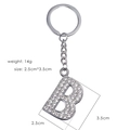 Silver metal letter B keychain with sparkling rhinestones on a white background - Letter B