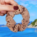 Detail of khaki chiffon scrunchie with black polka dots shown in a handheld view - Khaki Polka Dot