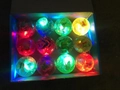 Close-up of 12 LED glowing elastic balls with butterfly patterns in a carton box - 5.5CM Crystal Ball with String