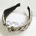 Detail of bohemian knotted headband with olive green leaf embroidery on beige fabric - Knotted Style / Leaf Knot
