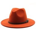 Detail of orange wool fedora hat featuring classic teardrop crown and black buckled band - Rust red