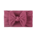 Close-up of soft jacquard nylon baby headband with large bow in dark pink color - Deep Purple