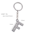 Detail of silver letter F keychain with sparkling rhinestones showing 2.2x3.5cm dimensions - Letter F